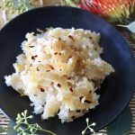 Close up of Close up of a crispy fried rice on a black plate.