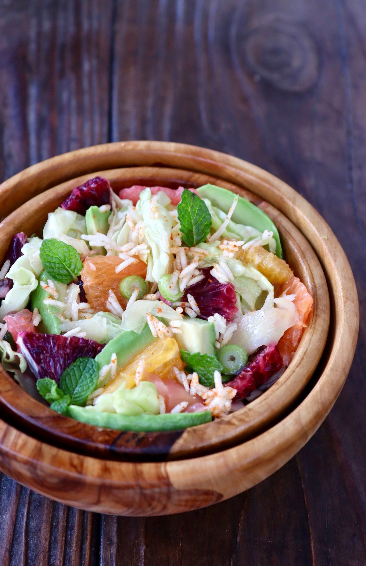 wooden bowl on wood background with wasabi pickled ginger salad with blood oranges