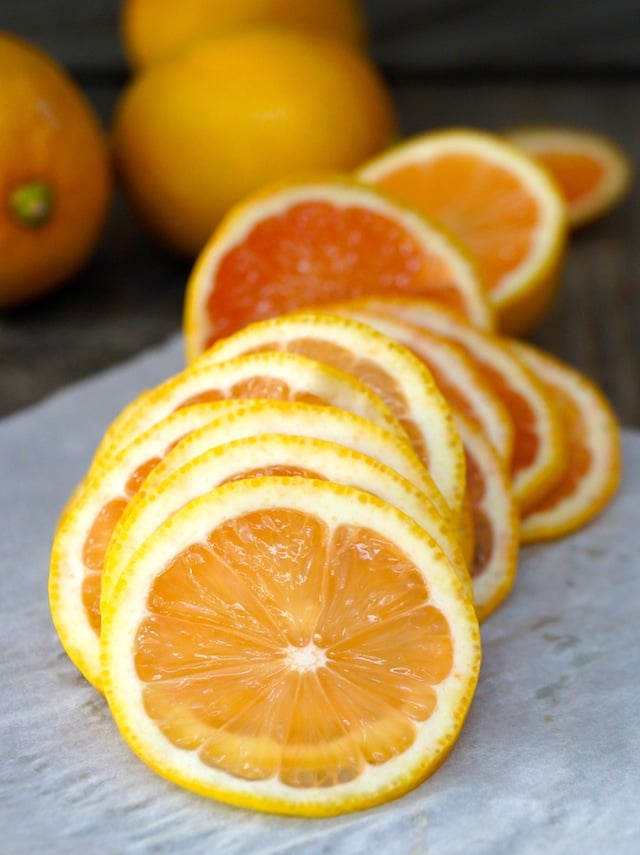 Pile of sliced pink lemons on parchment paper 