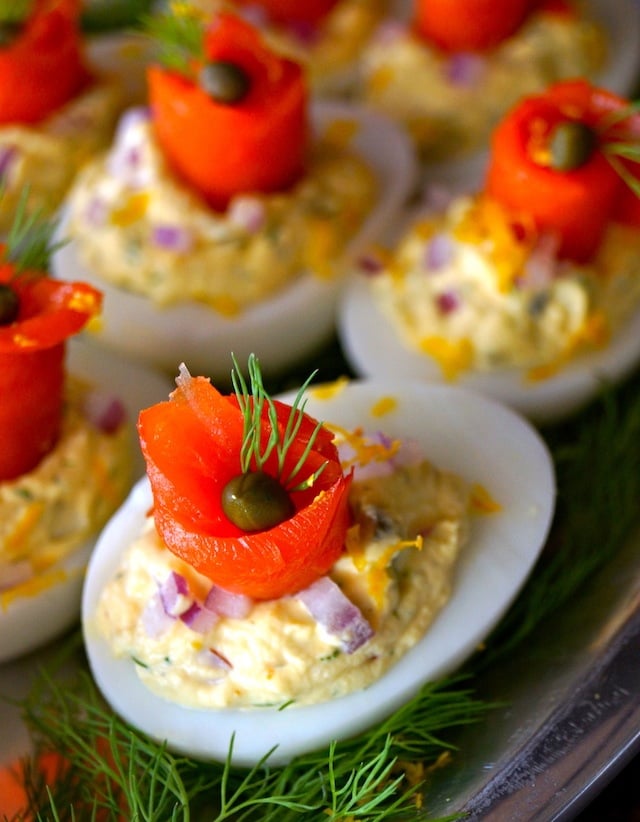 A side shot of smoked salmon on top of deviled eggs. 