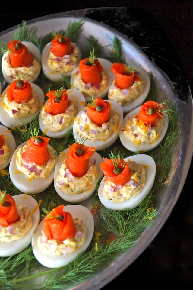 Smoked Salmon Deviled Eggs with fresh dill on a silver platter