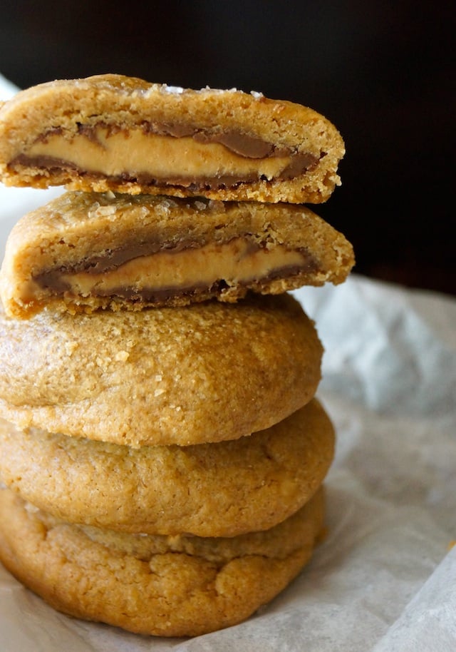 stack of Double Peanut Butter Chocolate Cookies, with the op one cut in half to show peanut butter-chocolate filling