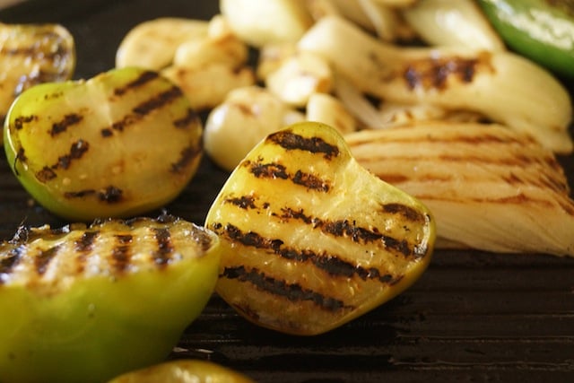 tomatillos and onions on grill with grill marks