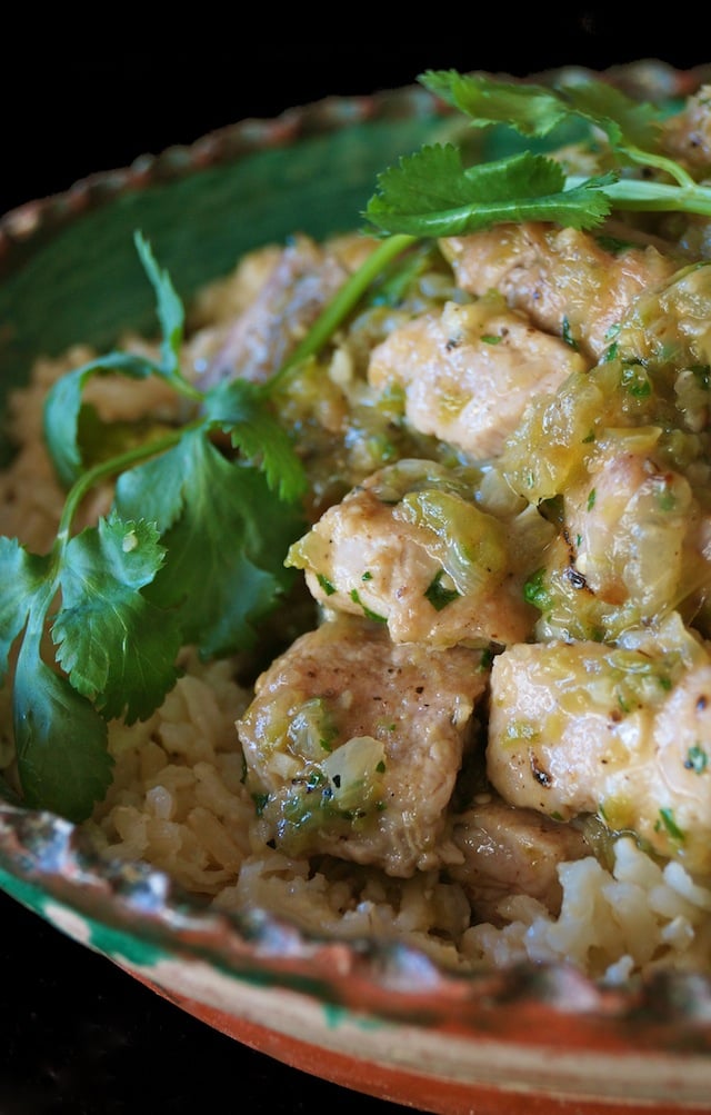 Puerco en Salsa Verde in green ceramic bowl with fresh cilantro