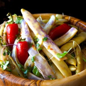 Dragon Tongue bean Salad with Honey Mustard Dressing in a wooden bowl with microgreens