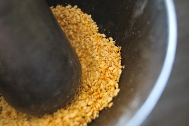 Sesame seeds in a mortar with a pestle