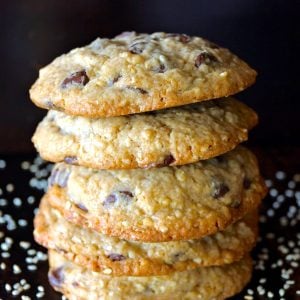 Stack of about 7 Sesame Chocolate Chip Cookies on black background.