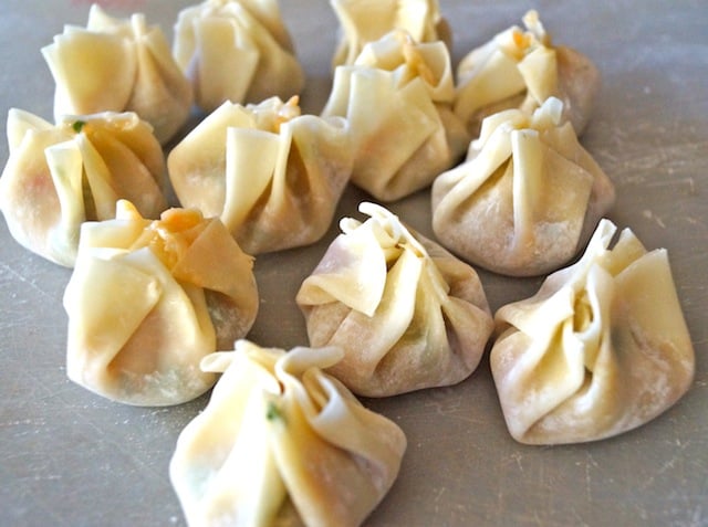 several Garlic Ginger Chicken Dumplings on parchment