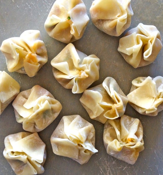 top view of several raw dumplings on parchment