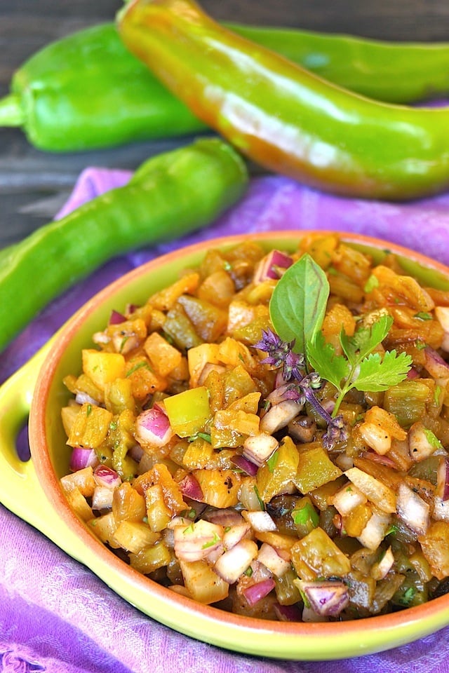 Roasted Double Hatch Chile Pineapple Salsa Recipe in a light green, teracotta rimmed, round bowl on a purple cloth.