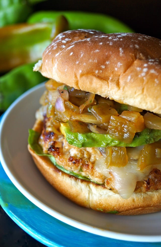 Hatch Chile Pineapple Salsa Turkey Burger Recipe on a white plate with fresh hatch chiles in the background