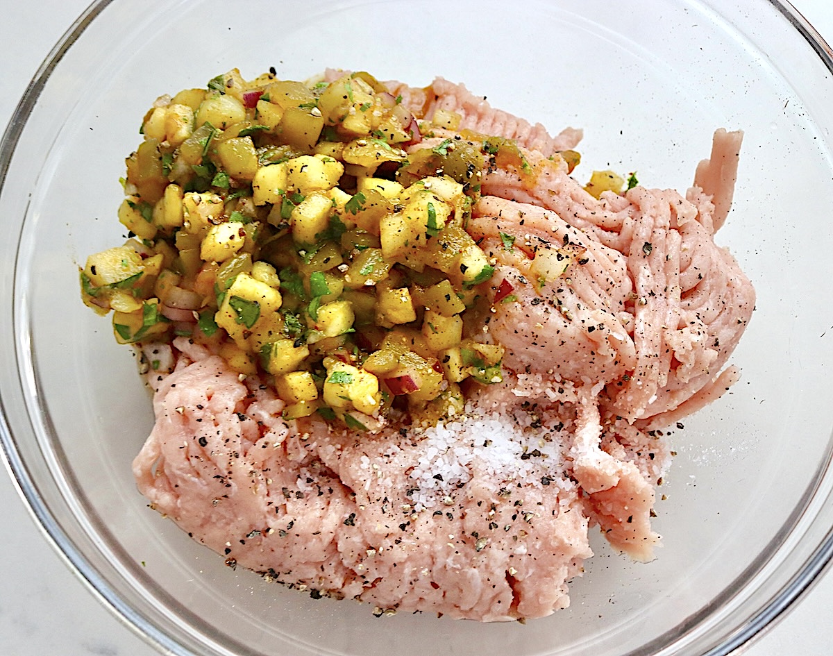 Hawaiian-Turkey-Burger-Recipe Glass bowl with ground turkey and pineapple salsa.