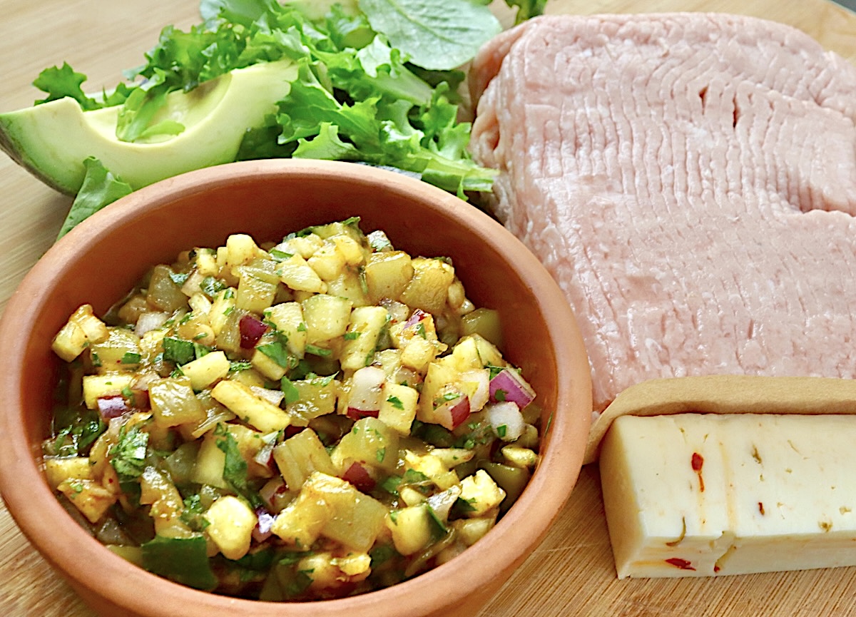Hawaiian-Turkey-Burger-Recipe Ingredients for pineapple turkey burger including pepper jack cheese, bowl of pineapple salsa, ground turkey, avocado and lettuce.