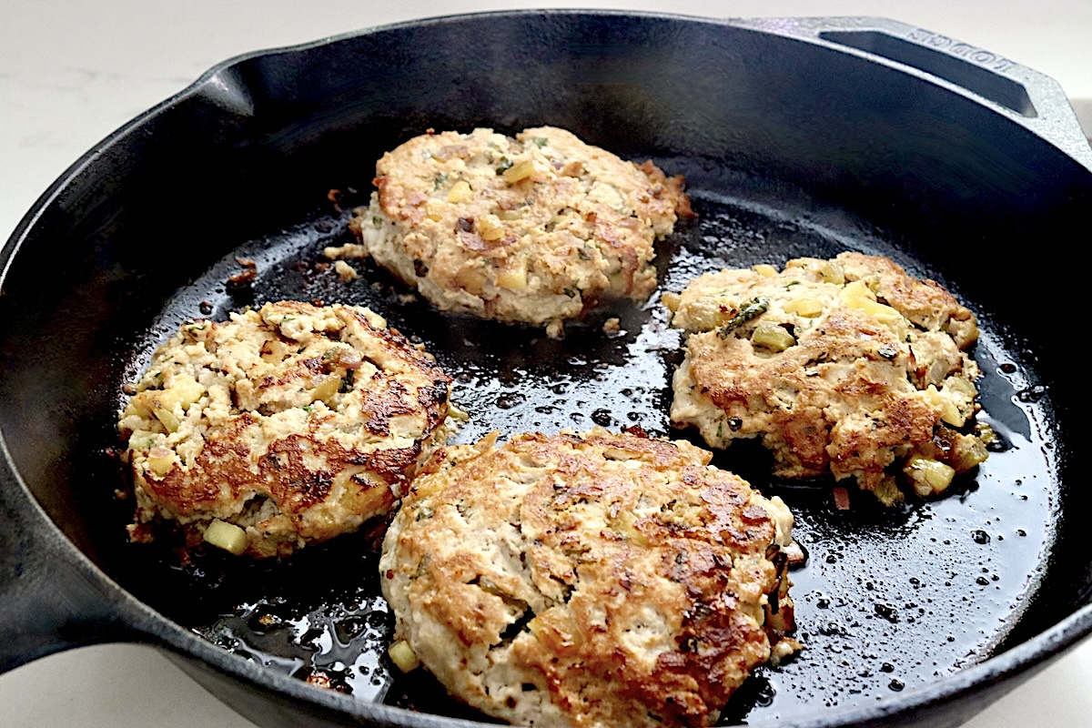 Hawaiian-Turkey-Burger-Recipe Cooked turkey pineapple burgers in a cast iron skillet.