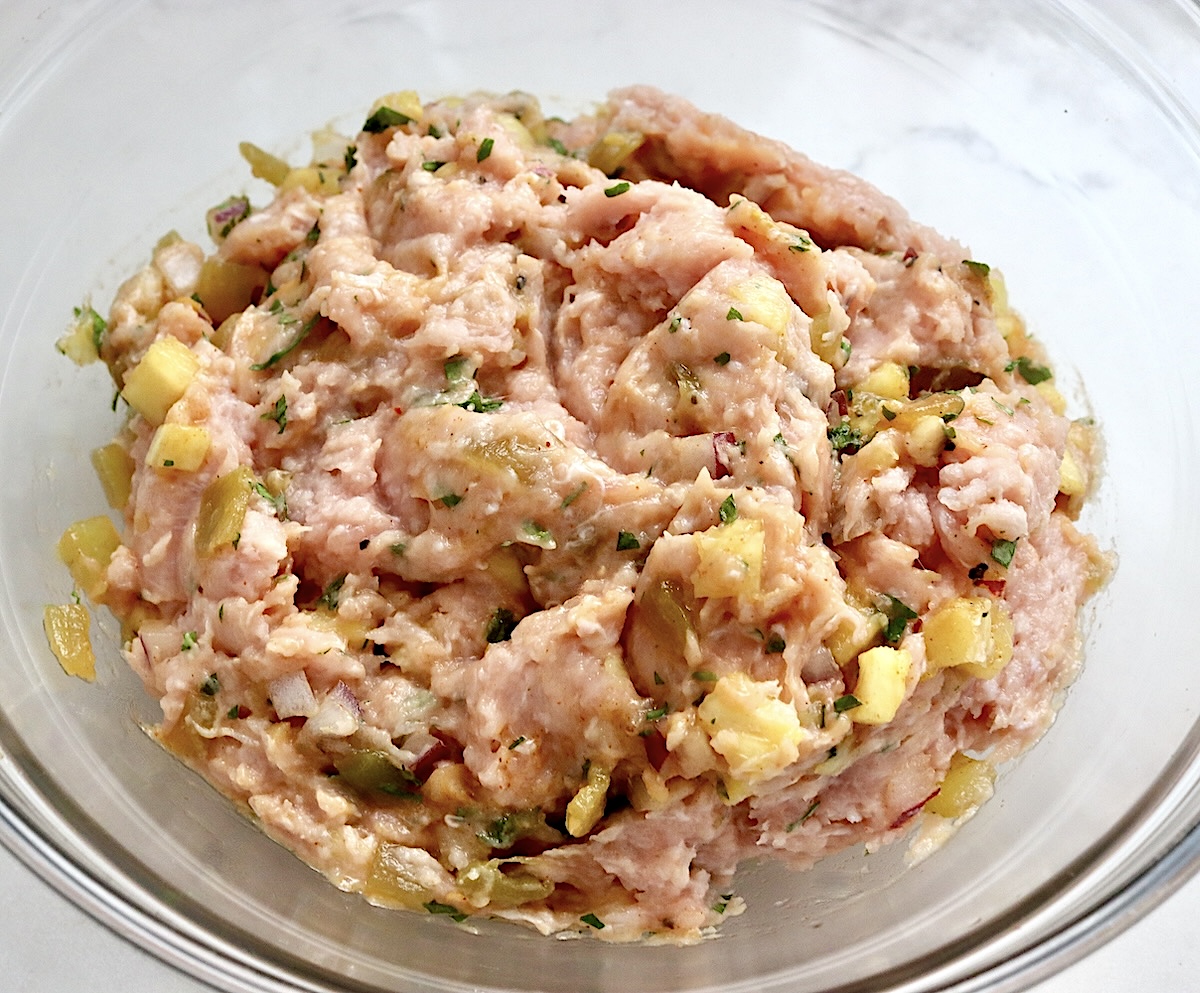 Hawaiian-Turkey-Burger-Recipe Mixture of ground turkey and pineapple salsa in a glass bowl.