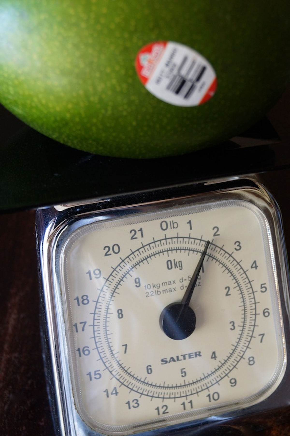 Keitt mango on a kitchen scale.
