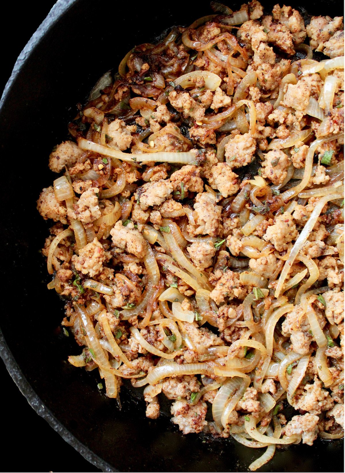 sausage and onion in cast iron skillet