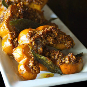 A few slices of Pecan Crusted Acorn Squash on white plate