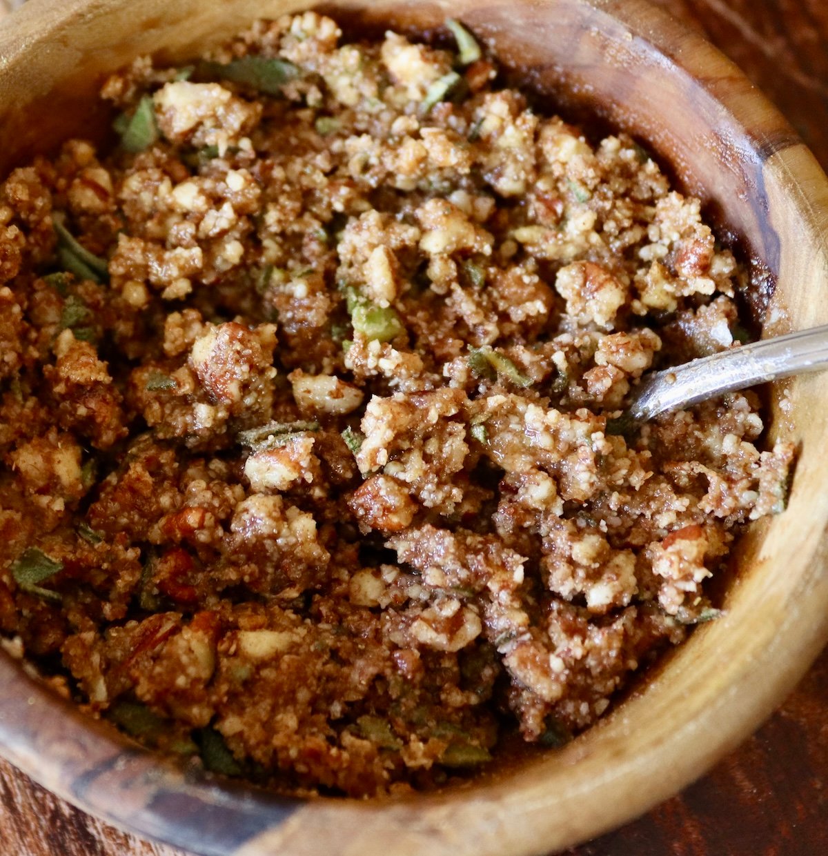 Ground pecans, brown sugar and sage mixture in a small wooden bowl.