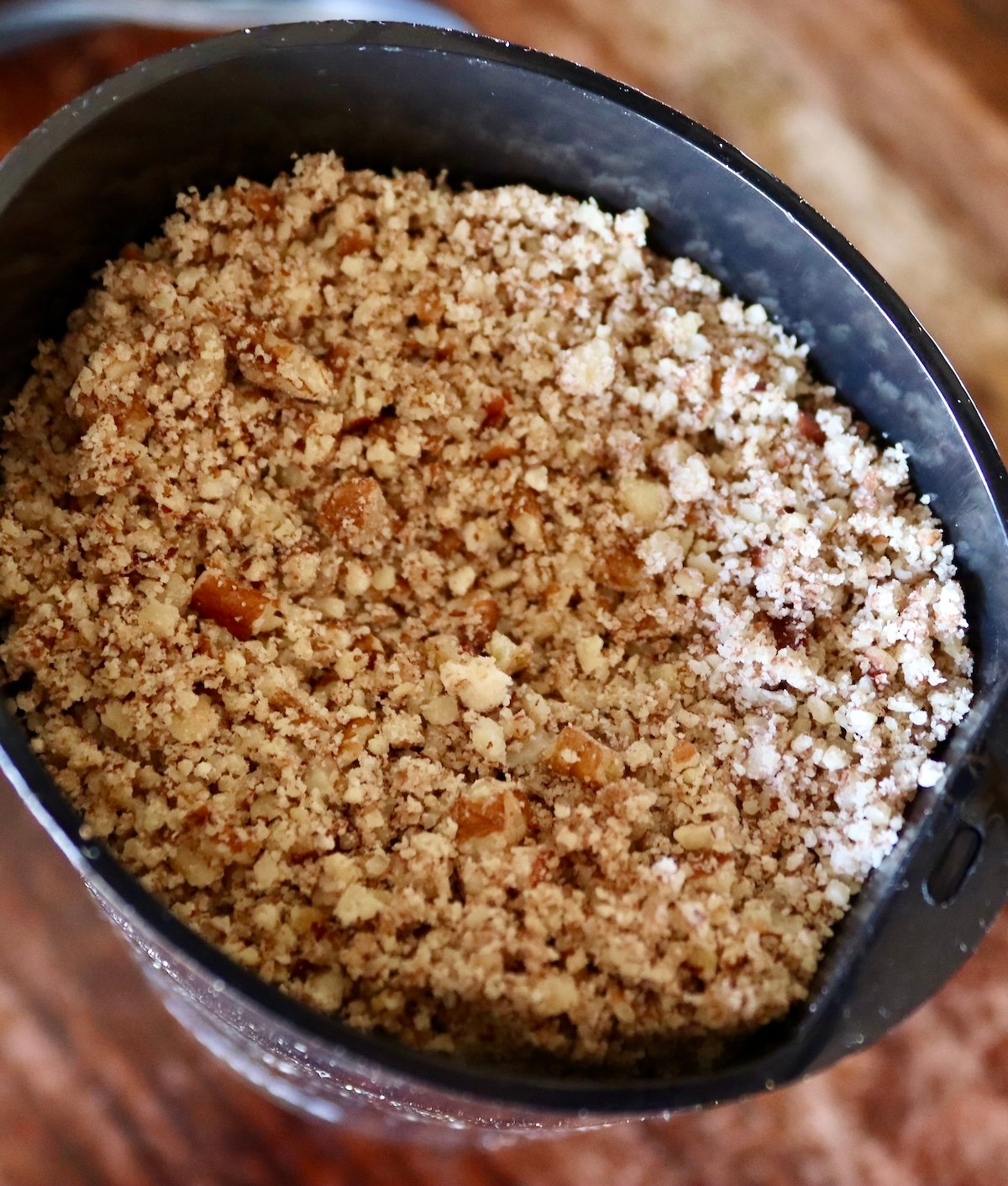 Ground pecans in a coffee grinder.