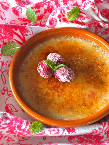 Cranberry Amaretto Crème Brûlée -- It's rich, creamy and full of delicious bites of fruit. Beautifully presented, this is an elegant and festive dessert for the holiday season.