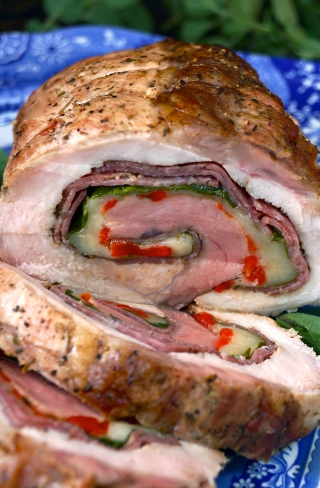 Salami Provolone Stuffed Pork Loin sliced beautifully on a blue platter