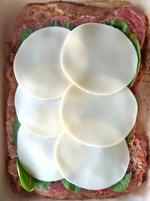 salami, spinach and provolone in layers on top of butterflied pork loin