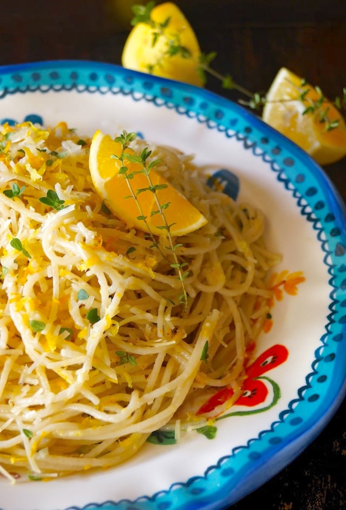 Meyer-Lemon-Spaghetti-with-Thyme Spaghetti with lemon and fresh thyme on a blue-rimmed ceramic dish.
