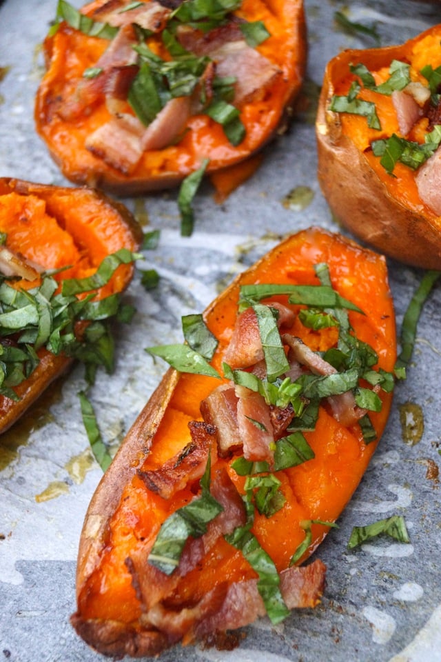 A few halves of Baked Sweet Potatoes with just the bacon and basil, getting ready for the oven.