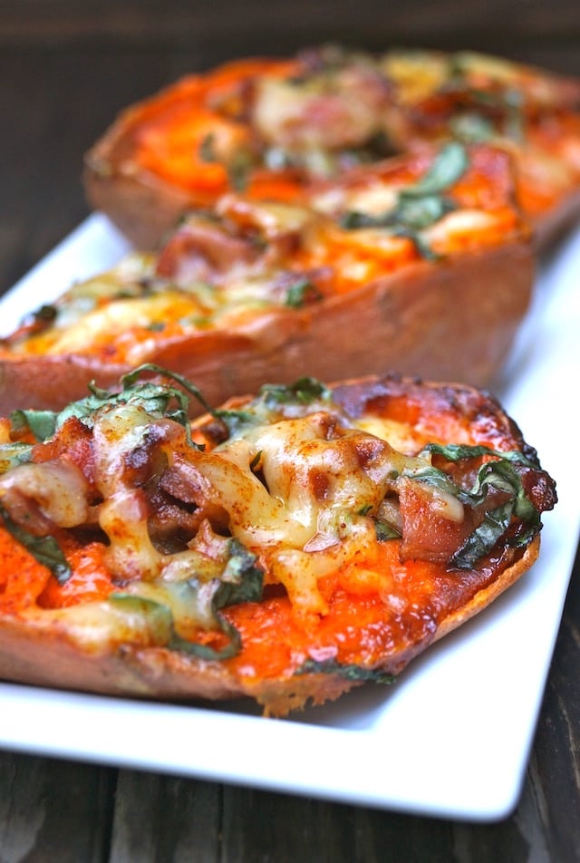 Close up of Baked Basil Sweet Potatoes with Bacon on white plate.