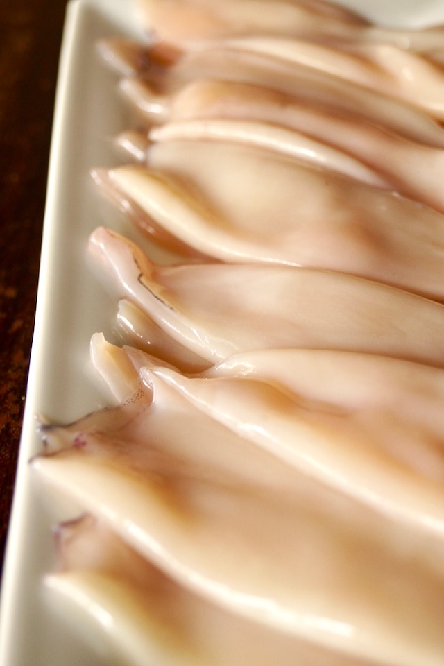 whole, cleaned squid on a white plate 