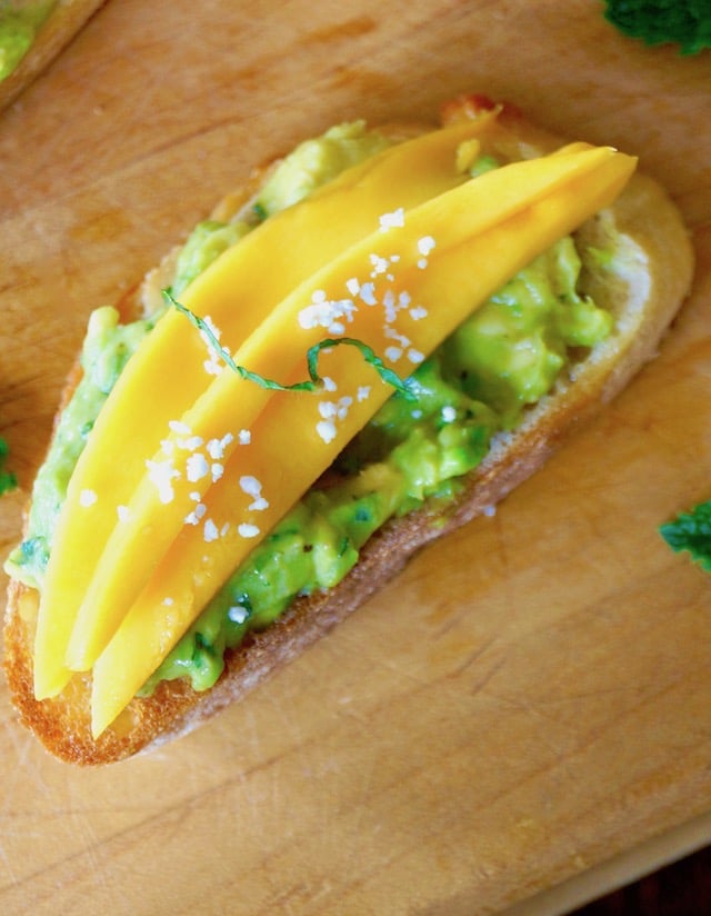 Avocado Toast Recipe with mango and mint on cutting board