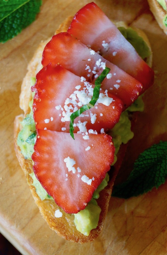 Avocado Toast Recipe with strawberry and mint on cutting board