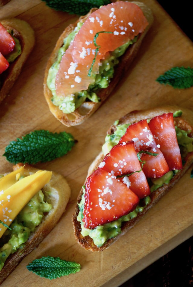 Avocado Toast Recipe with with strawberry, mango and grapefruit on cutting board