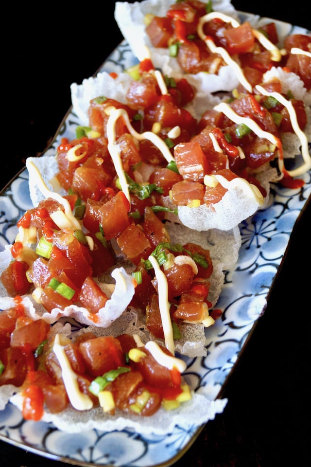 Spicy Poke Nachos on a pretty blue floral plate