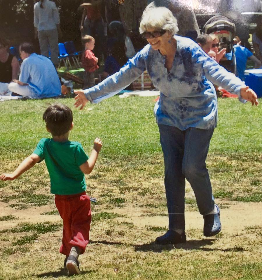 My-Mom running to my toddler son on the grass.