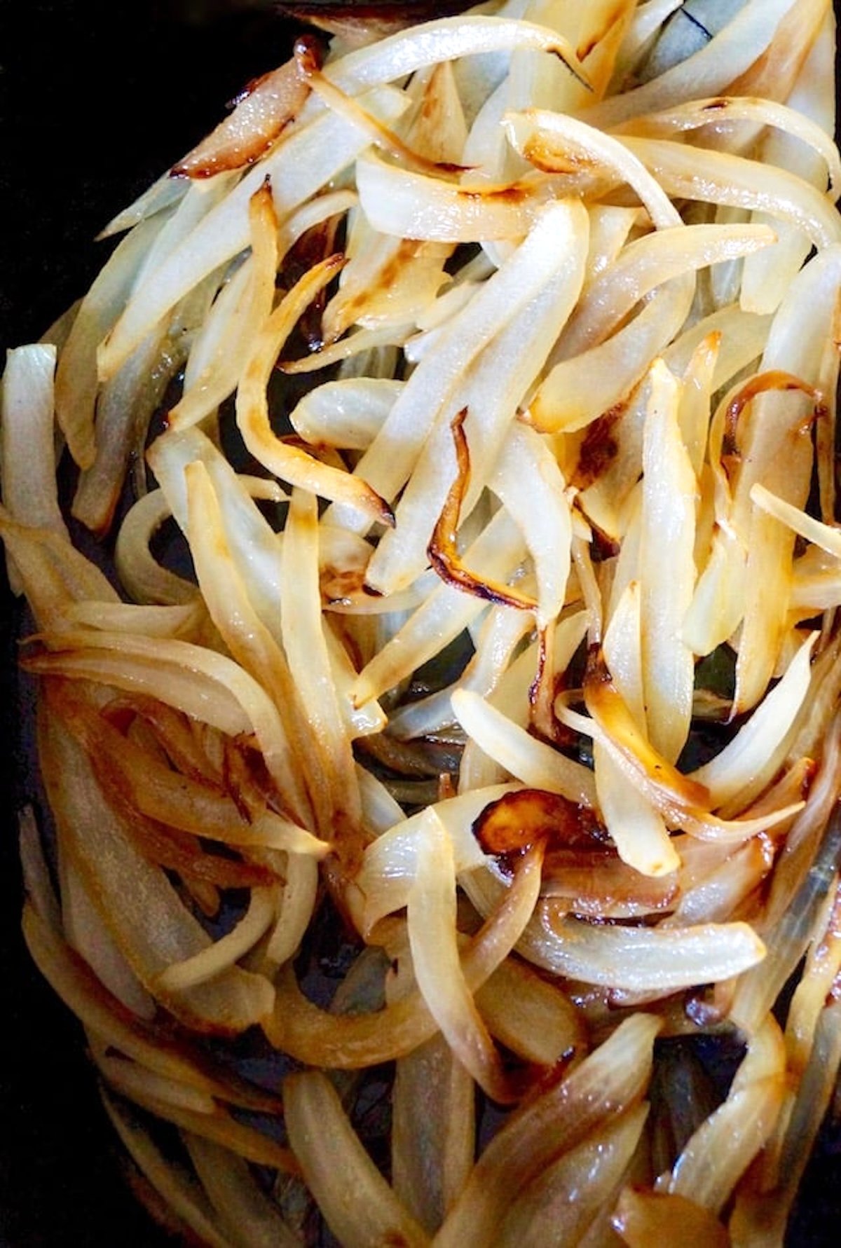 Pan filled with golden onion slices.