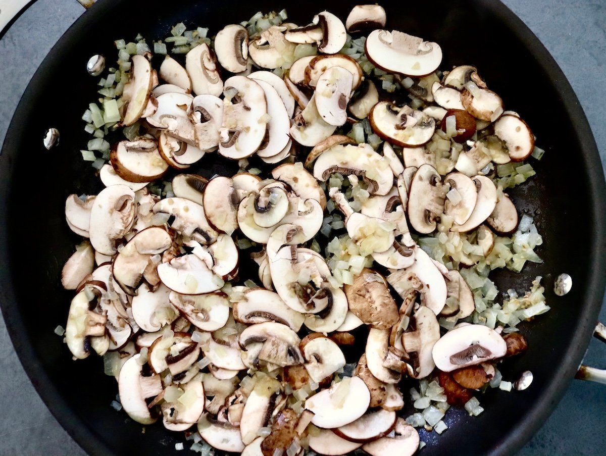 Portuguese-Style Sausage-with-Mushrooms Skillet full with sliced mushrooms and diced onion.