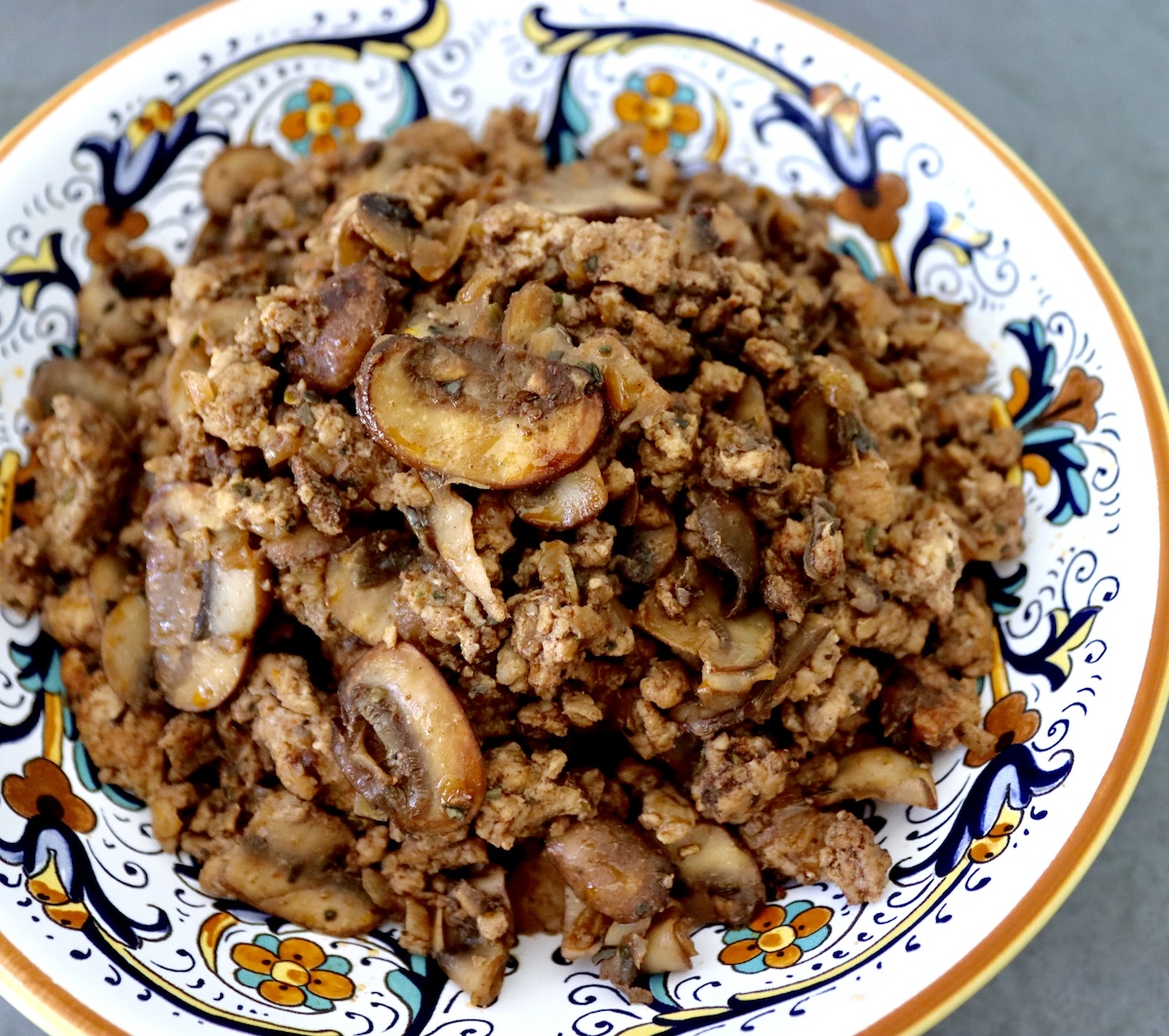 Italian painted bowl filled with deconstructed Portuguese sausage.