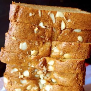 Tall stack of sliced Macadamia Bread on parchment paper.