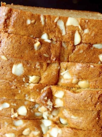 Tall stack of sliced Macadamia Bread on parchment paper.