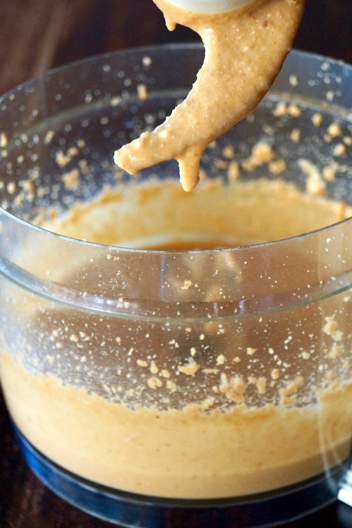 Food processor bowl filled with macadamia nut butter.