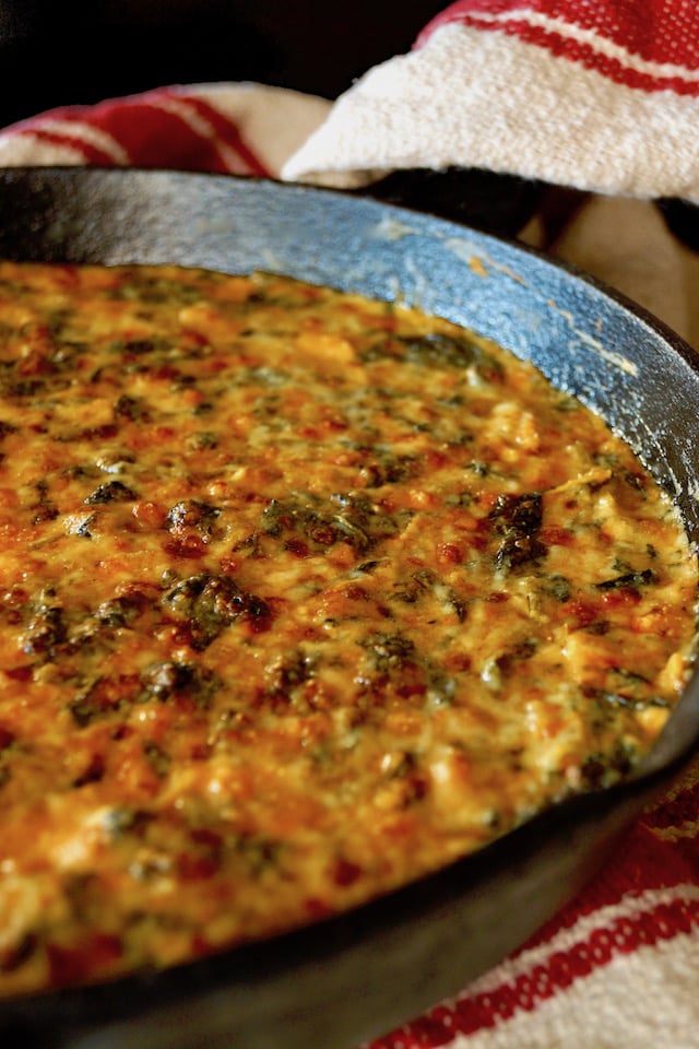 Gruyère Spinach Dip Recipe with Spices and Artichokes in cast iron skillet