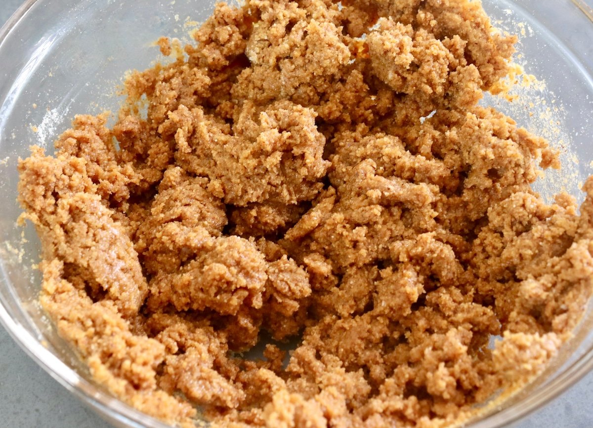 Almond butter bread batter before fluffy egg whites are added, in a glass bowl.