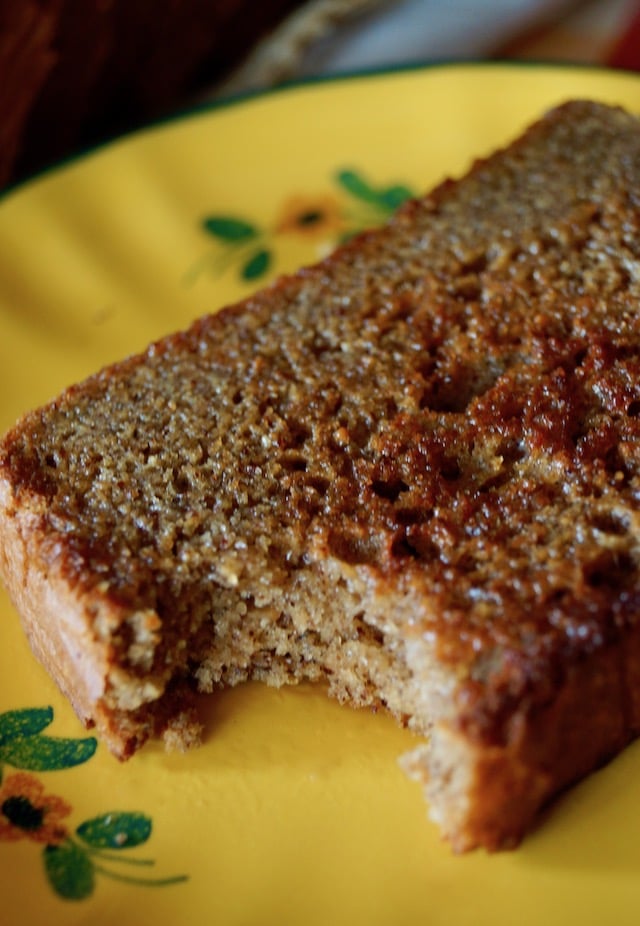 slice of toasted Gluten-Free Almond Butter Bread on a pretty yellow plate, with one bite taken out of it