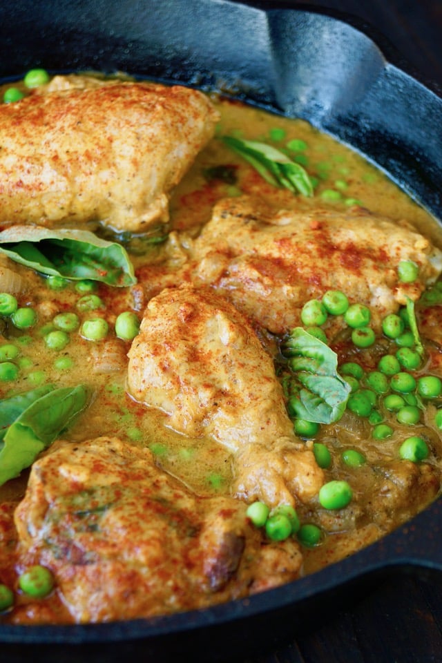 Skillet Sweet Potato Chicken Recipe in cast iron skillet with fresh peas and basil on top