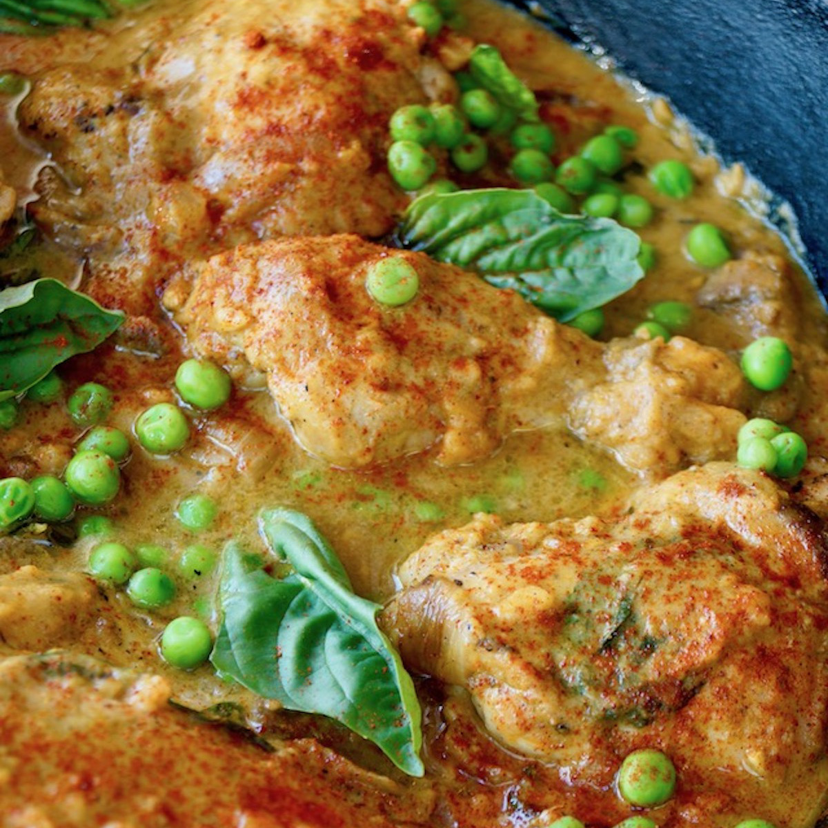 Rich-Slow-Cooked-Flavor—No All-Day-Commitment Spiced Sweet Potato Braised Chicken in a cast iron skillet.