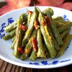 Small white and blue plate with Pecan Green Beans.