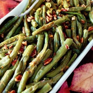 green beans with pecans in a white dish