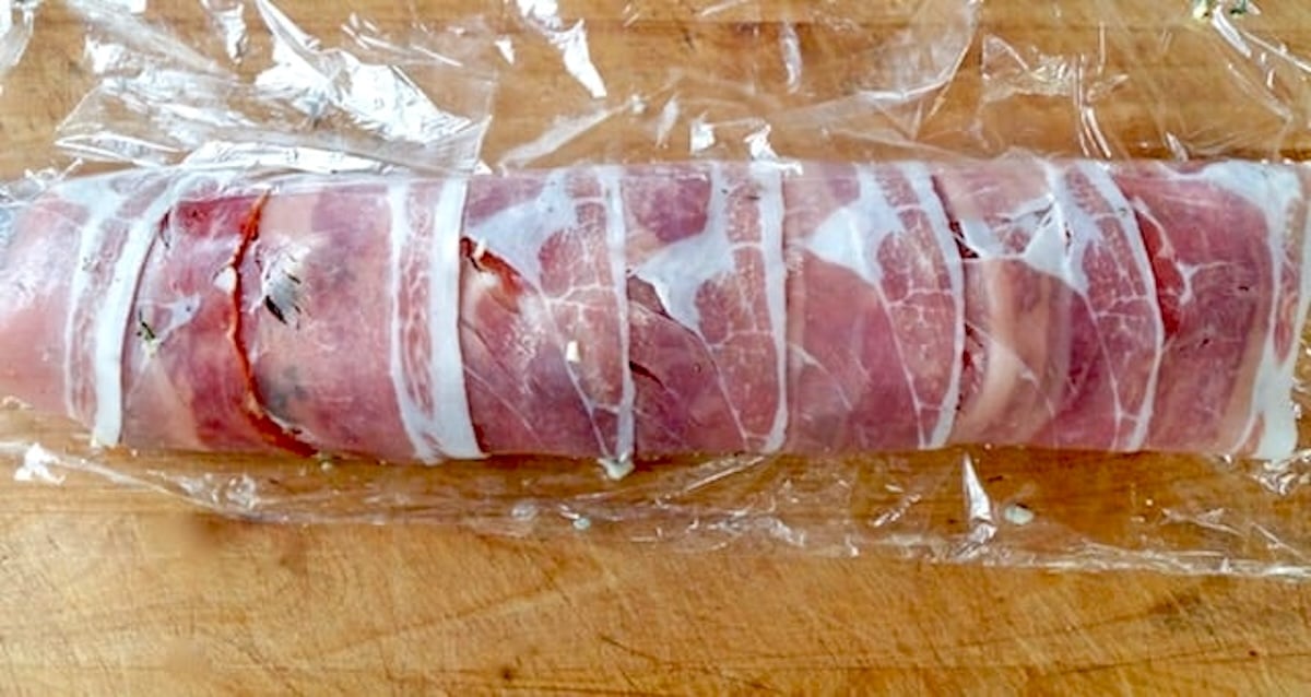 Rolled prosciutto wrapped pork with sliced persimmons inside.